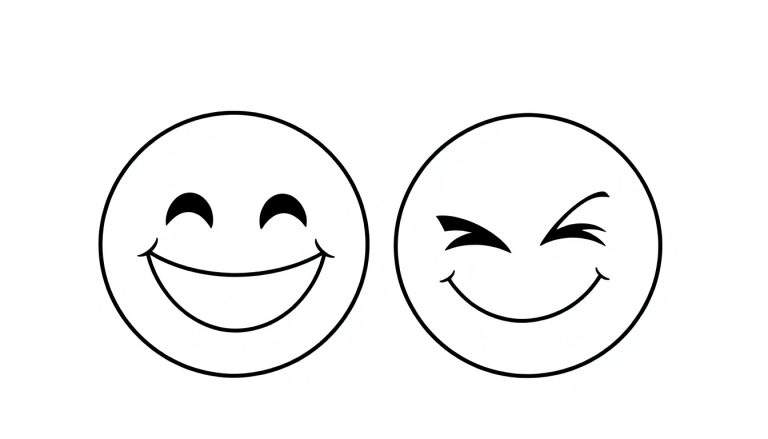 Dos emojis en una placa de color: uno sonriente y otro guiñando un ojo.
